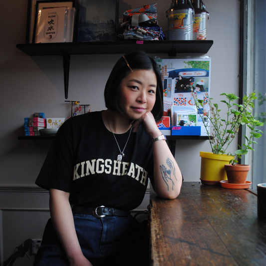 Brumbox Kings Heath athletic varsity style logo printed in cream on the chest of a black t-shirt (front)