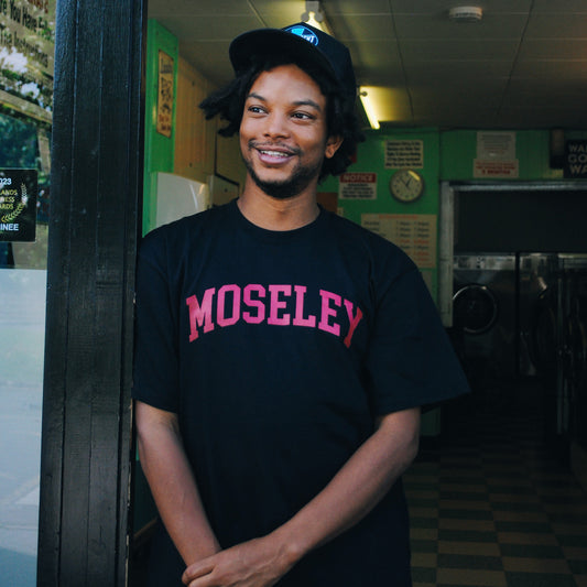 Model wears Brumbox's Moseley athletic style vintage black T-shirt
