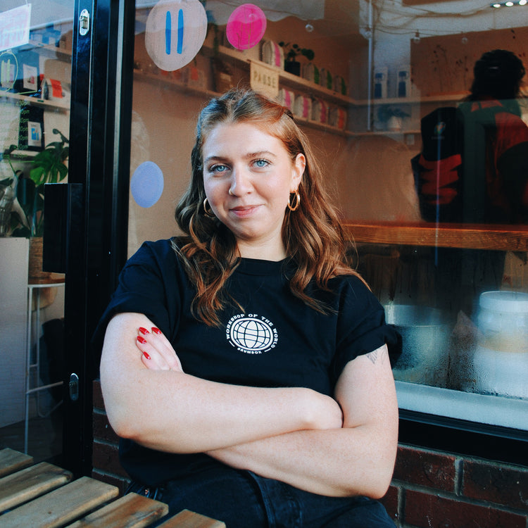 Brumbox Made in Birmingham, workshop of the world T-shirt in black (front) worn by a barista from Pause Coffee shop & Bakery