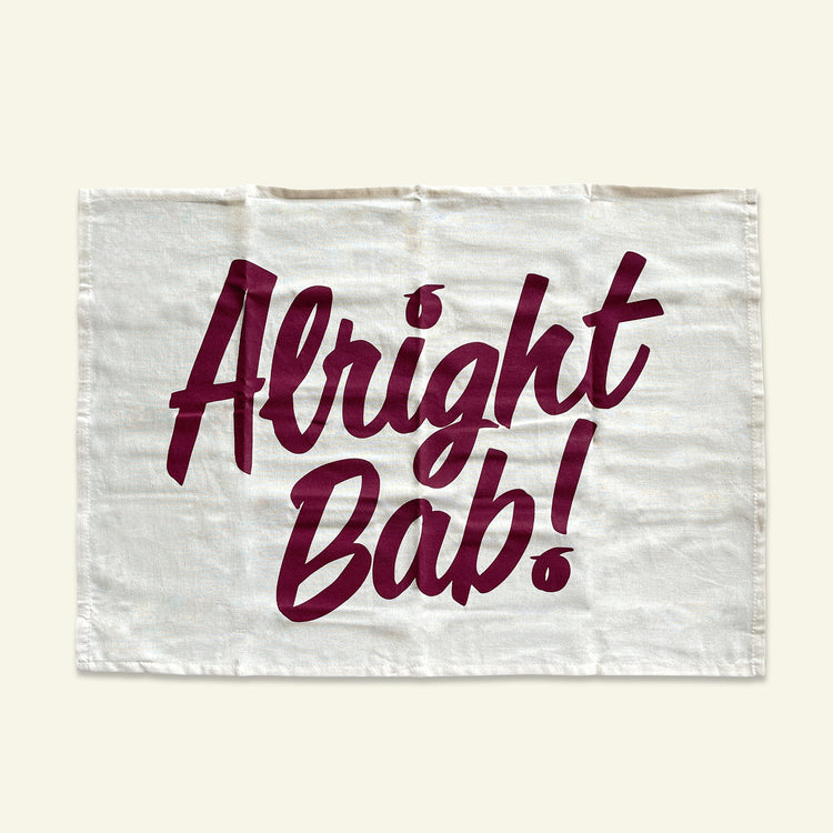 Brumbox Alright Bab cotton kitchen tea towel laid out flat