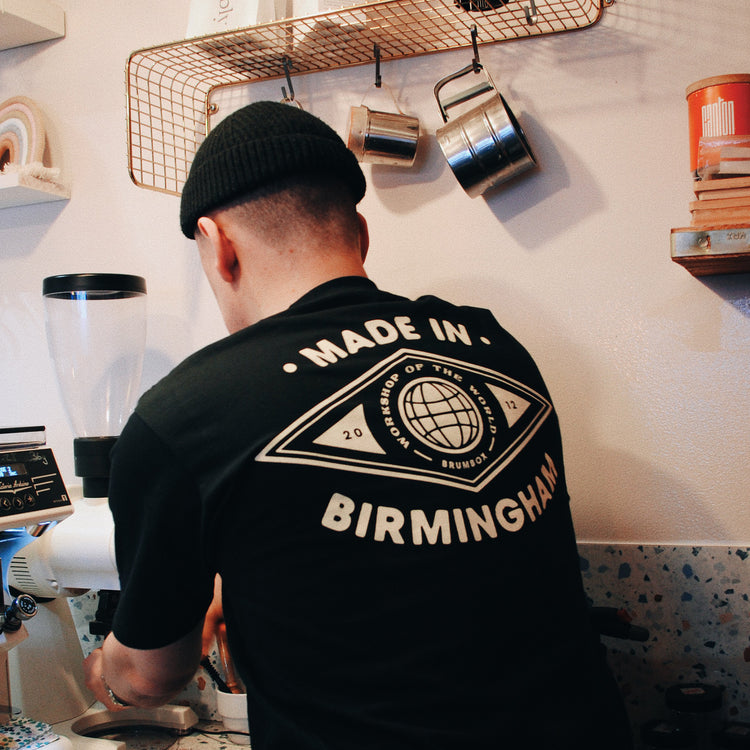 Brumbox Made in Birmingham, workshop of the world T-shirt in black (back) worn by Rory from Pause Coffee shop & Bakery