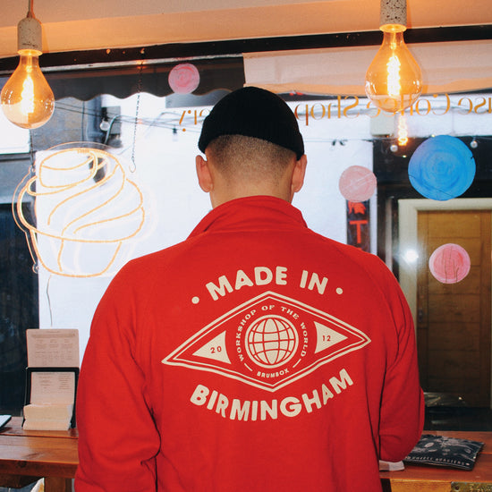 Brumbox Made in Birmingham, workshop of the world 1/4 zip sweatshirt in red (back) worn by Rory from Pause Coffee shop & Bakery